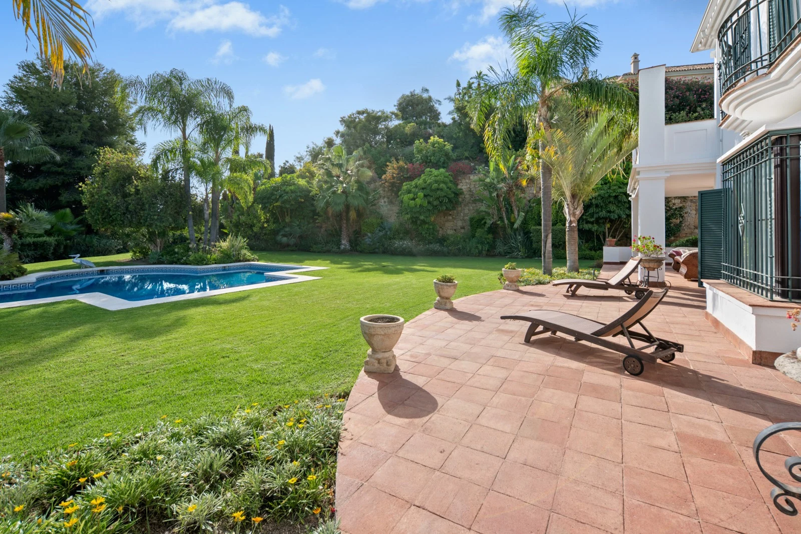 Sunny terrace beside the lawn and private swimming pool