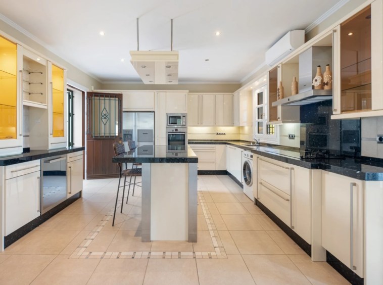 Fitted kitchen with island and built-in appliances