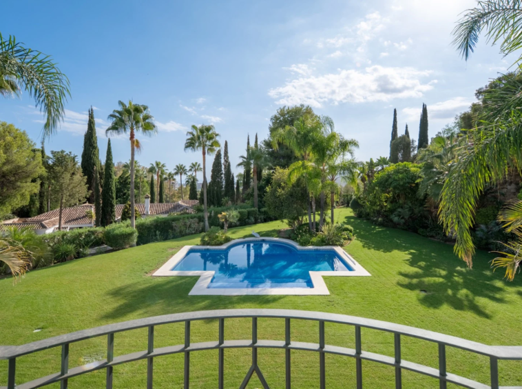 View across the private pool and mature garden