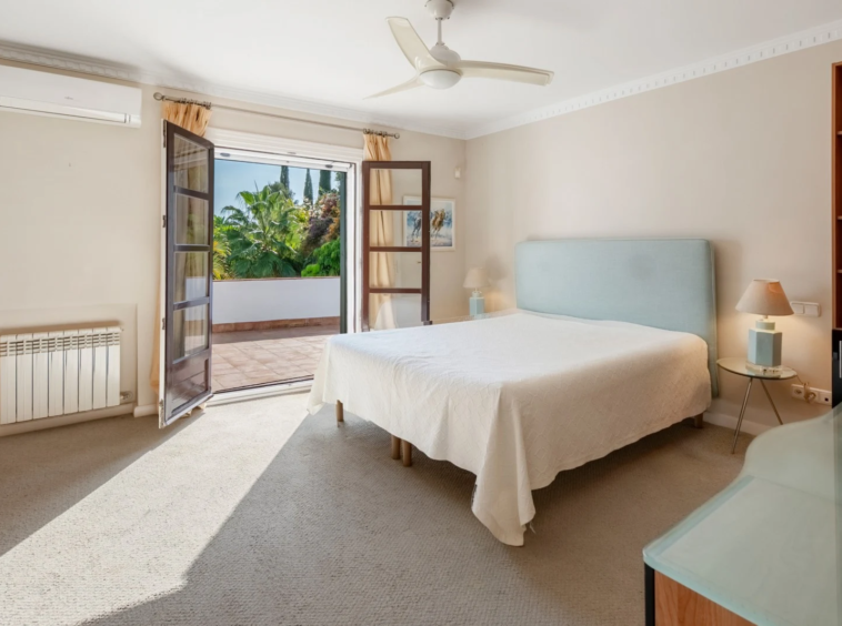Bedroom with timber-framed garden doors