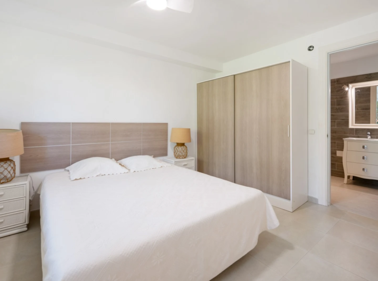 Bedroom with fitted wardrobes and natural light