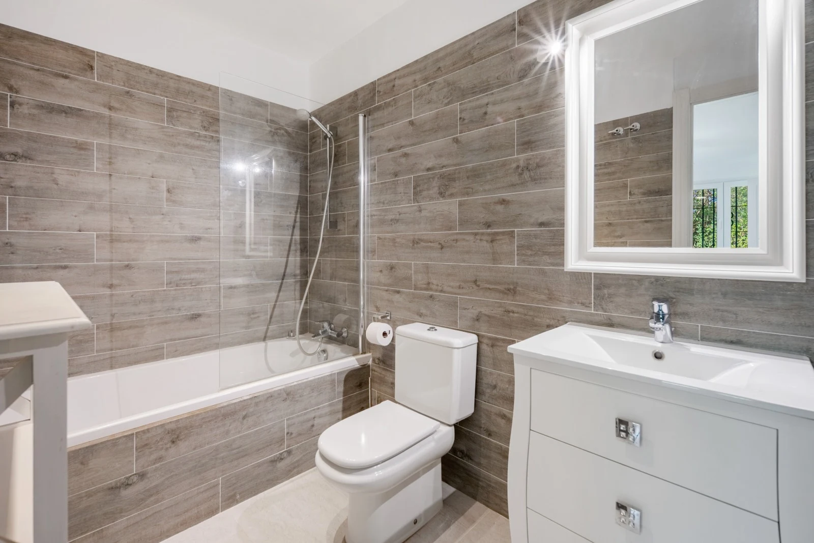Bathroom with bathtub and stone finishes