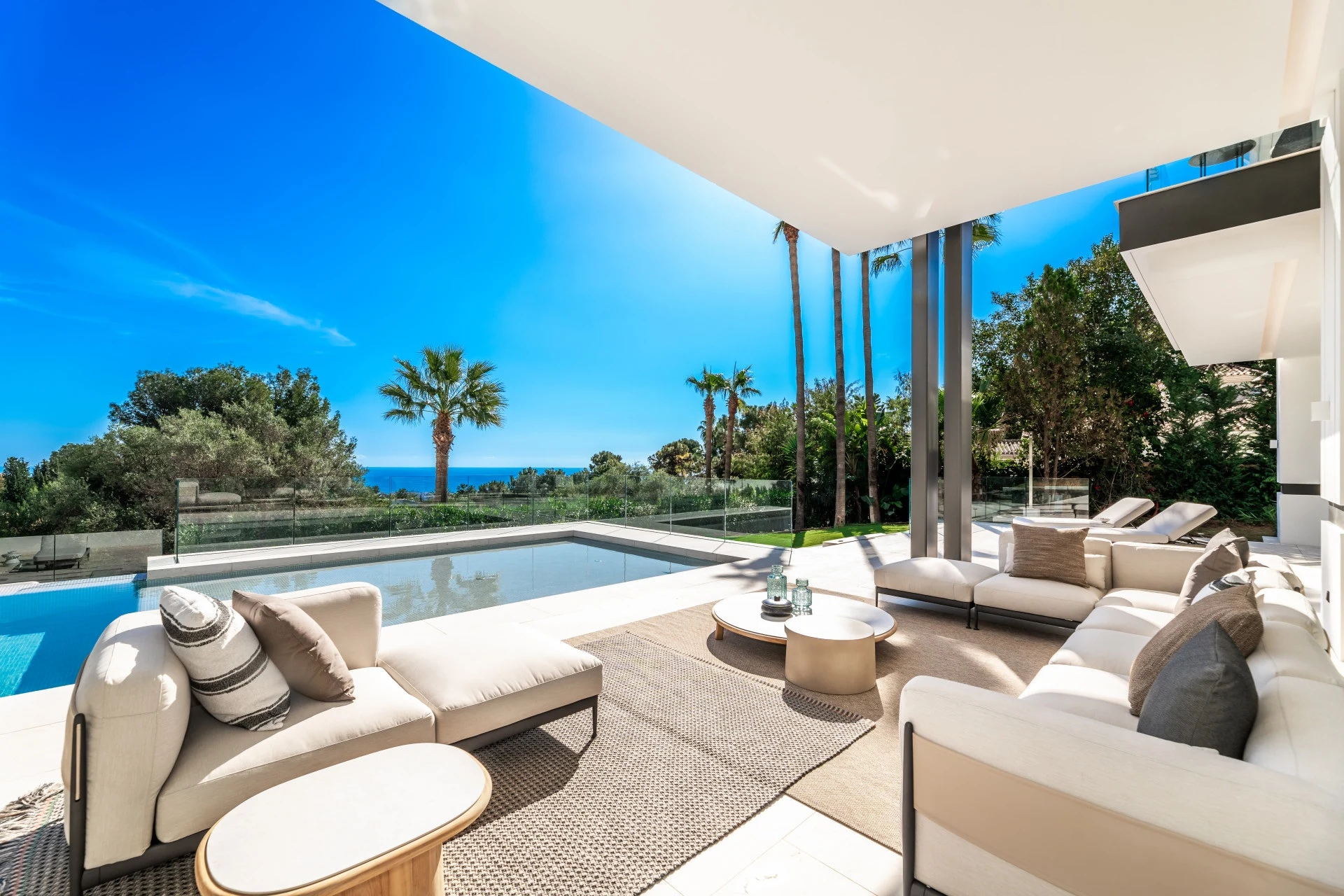 Poolside covered lounge with views towards the Mediterranean
