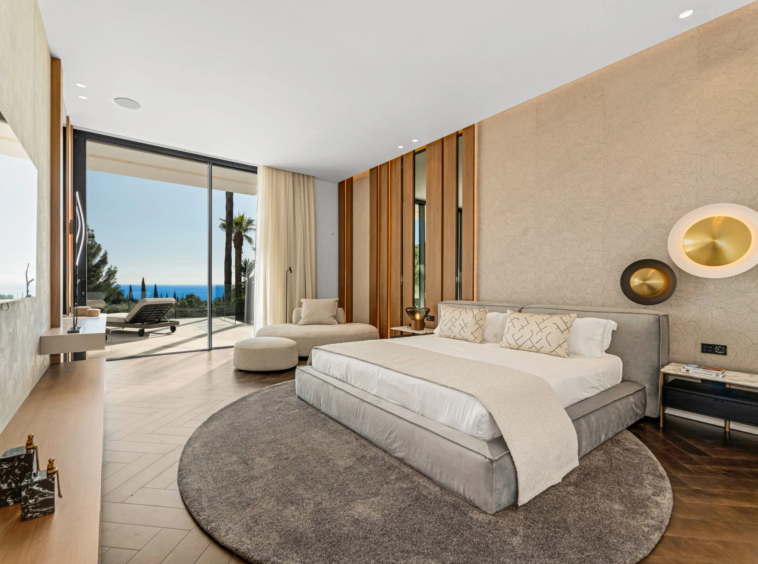 Principal bedroom with coastal views and terrace access