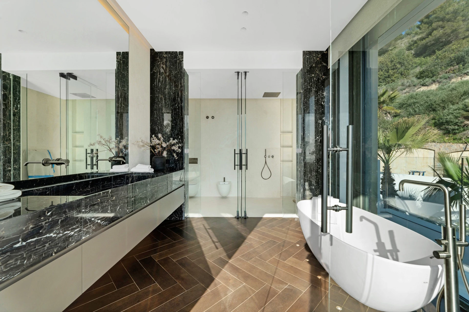 Bathroom with freestanding bathtub and garden-facing windows