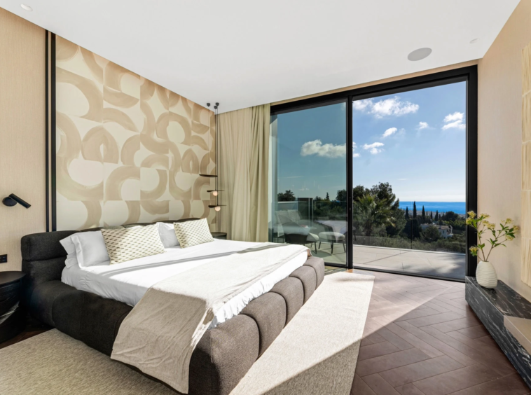Bedroom with glazed doors and sea views