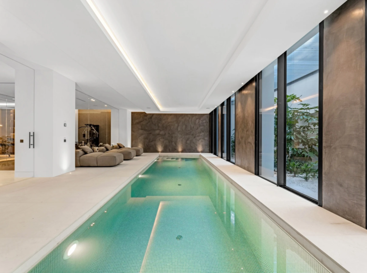 Heated indoor swimming pool beside a glazed courtyard