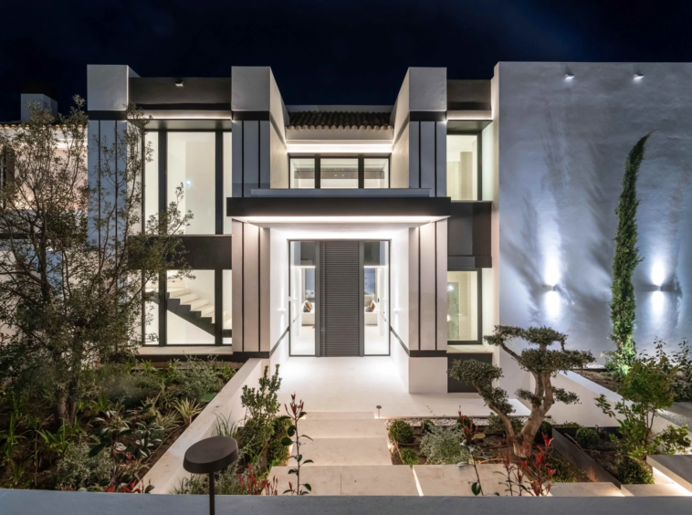 Villa entrance and double-height glazing at night