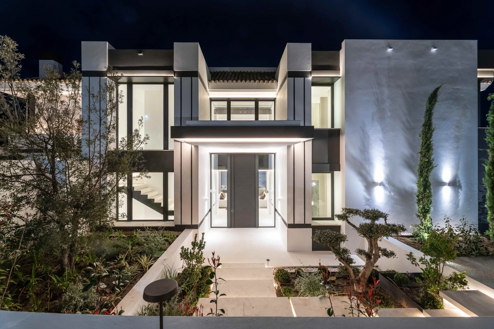 Villa entrance and double-height glazing at night