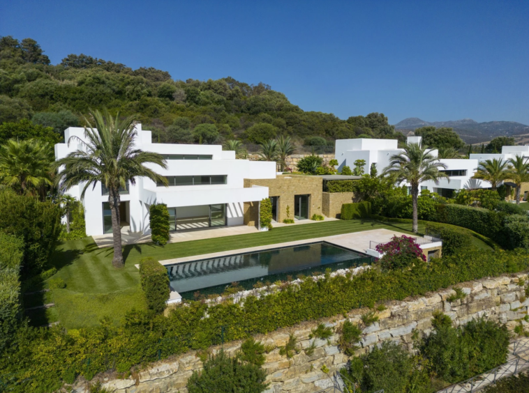 Elevated view of the villa and pool beside the golf course