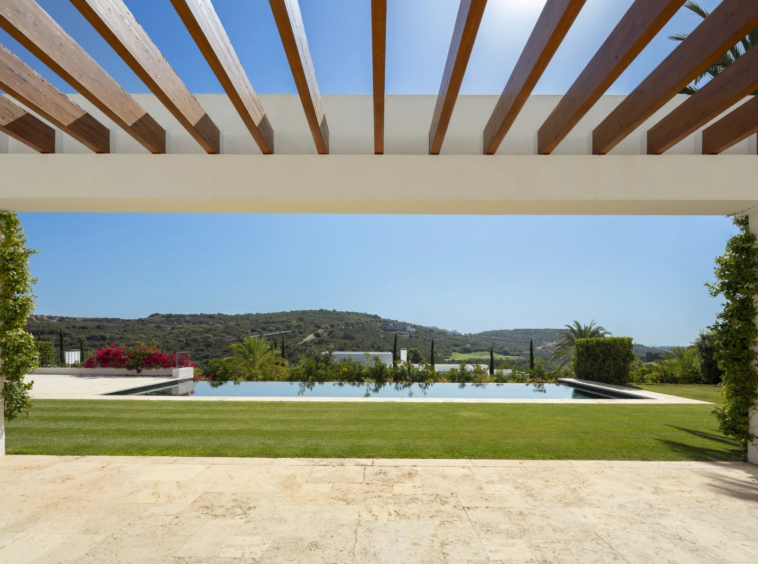 Shaded terrace with golf and mountain views