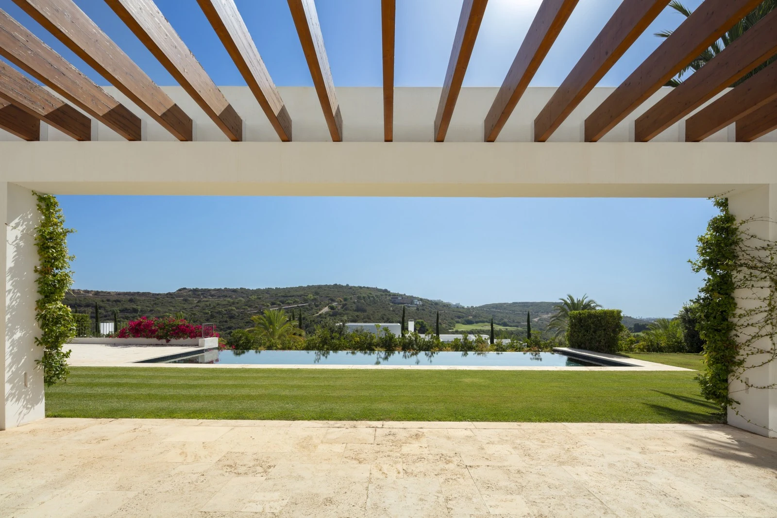 Shaded terrace with golf and mountain views