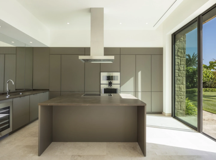 Fitted kitchen with dark cabinetry and island