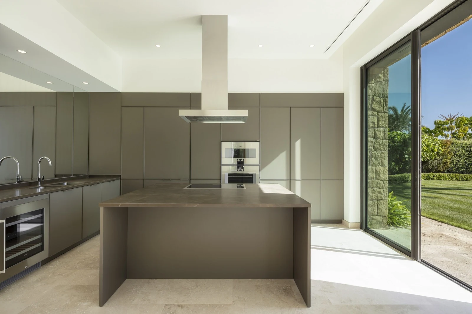 Fitted kitchen with dark cabinetry and island