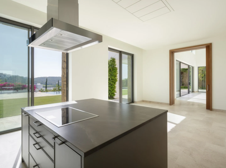 Kitchen island beside sliding doors to the terrace