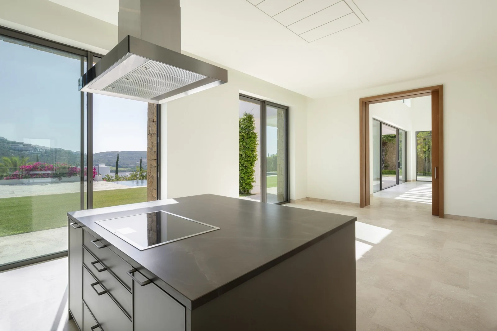 Kitchen island beside sliding doors to the terrace