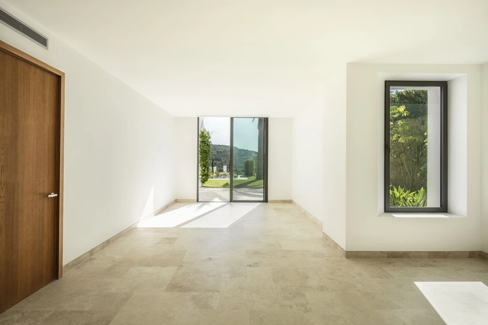 Bright bedroom with fitted wardrobes and garden access