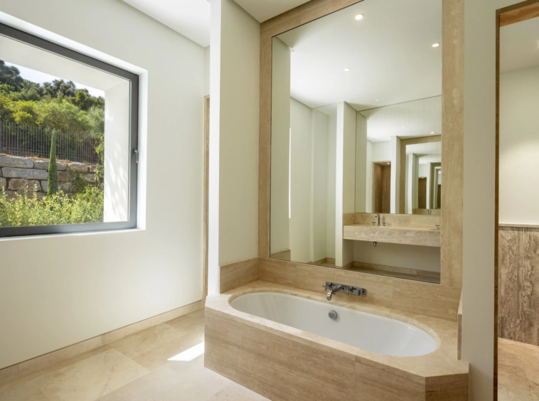 Stone-finished bathroom with vanity and mirror