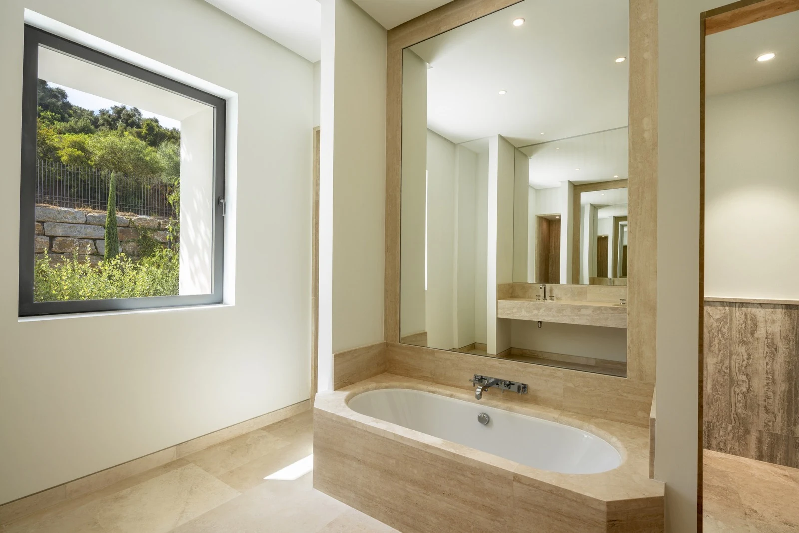Stone-finished bathroom with vanity and mirror