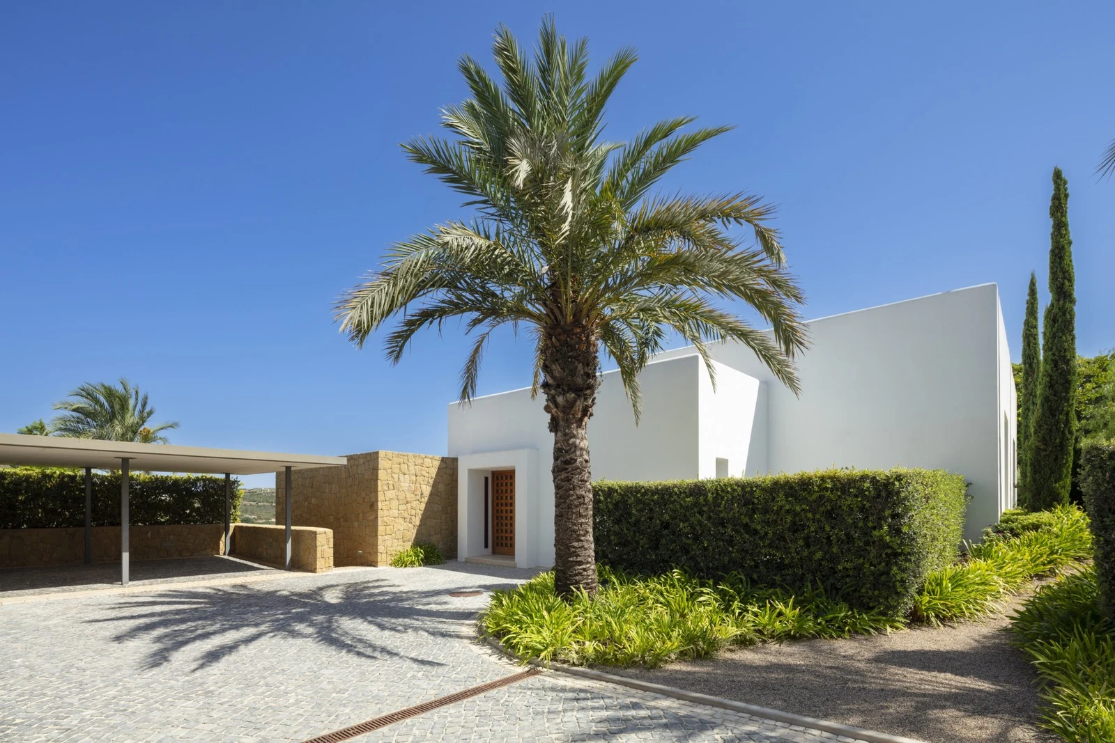 Private driveway and palm-lined entrance