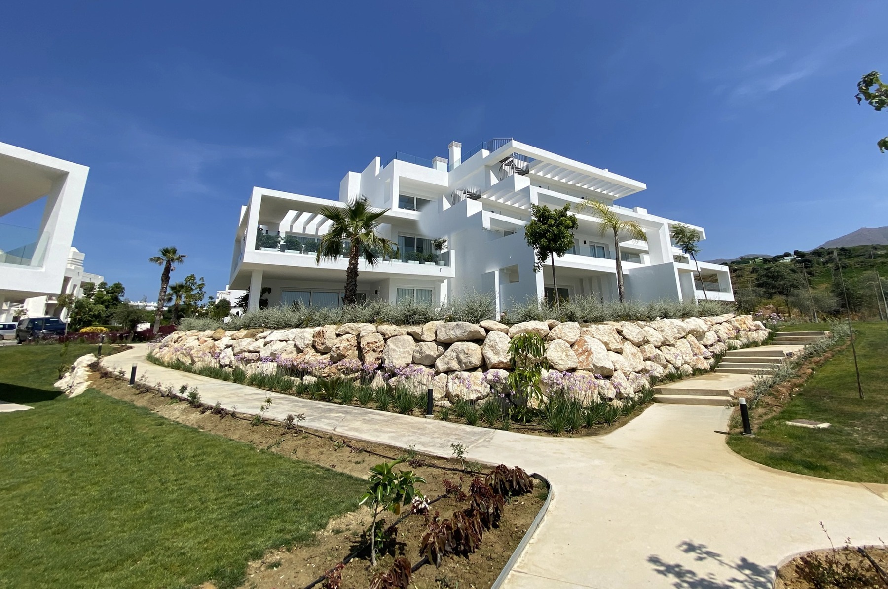 Completed residential buildings and landscaped gardens in Casares