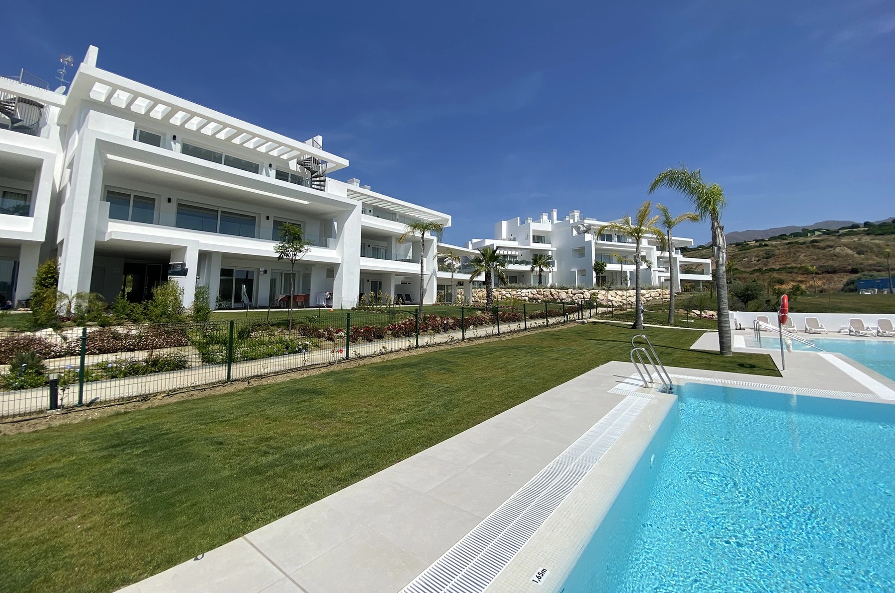 Communal swimming pool beside the completed Casares residences