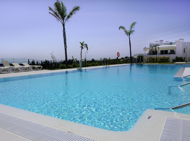 Outdoor communal swimming pool and sun terrace