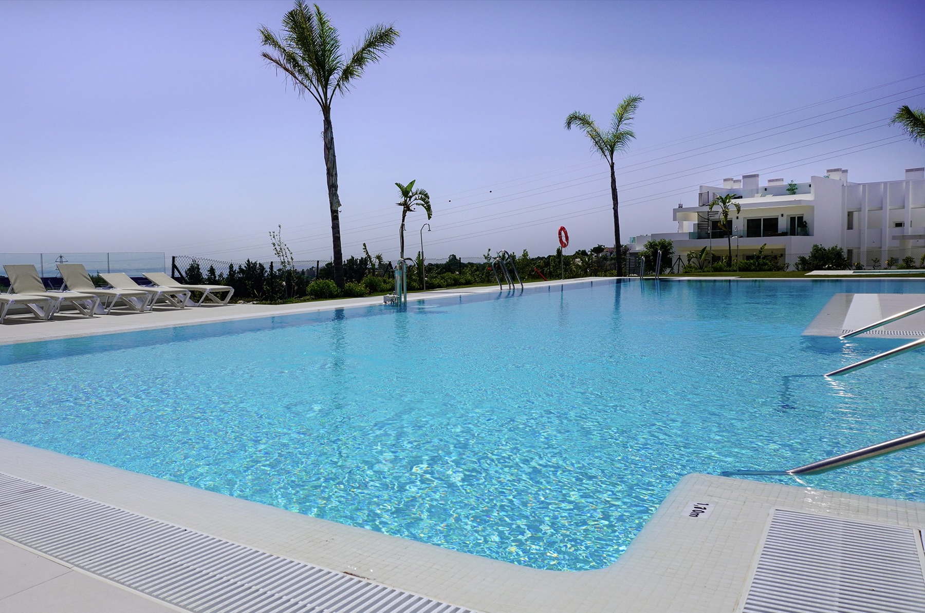 Outdoor communal swimming pool and sun terrace