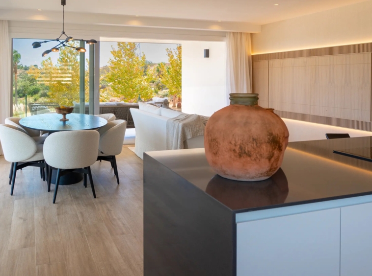 Kitchen island and dining space in the presentation apartment