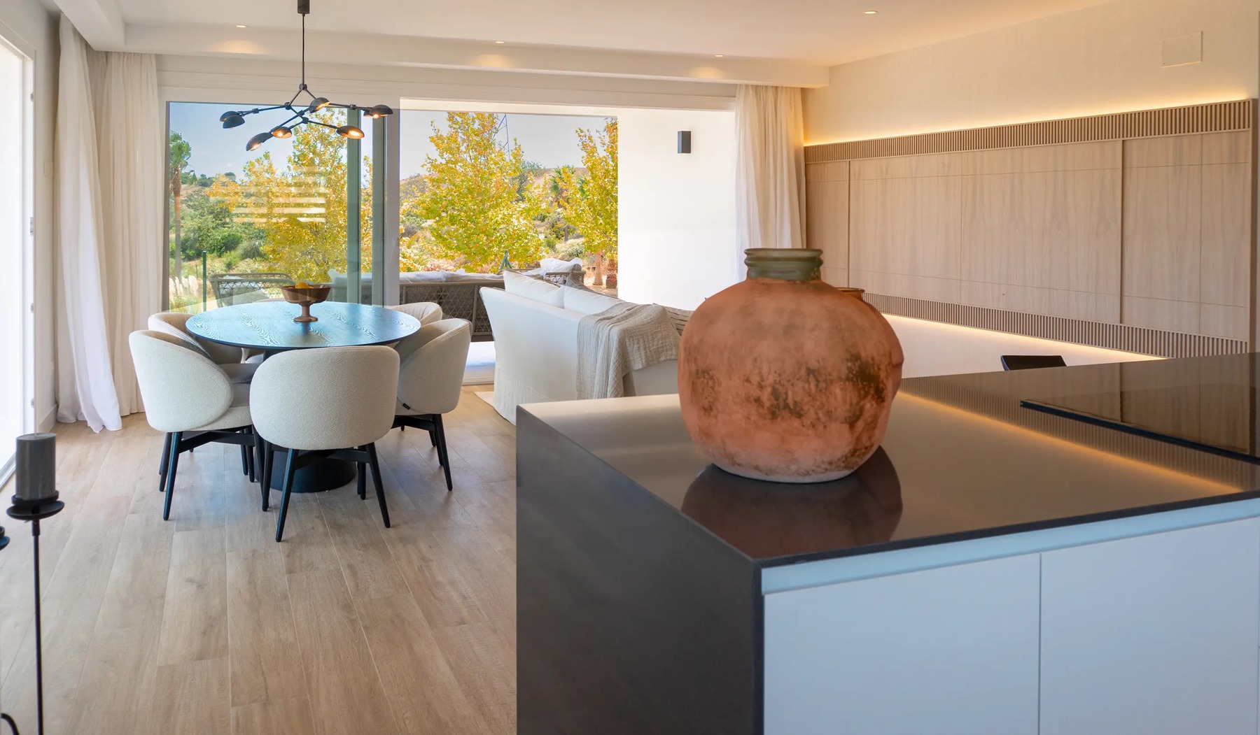 Kitchen island and dining space in the presentation apartment