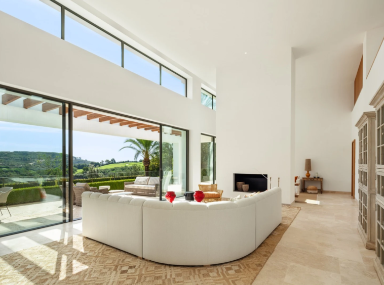 Bright living room with tall windows and a fireplace