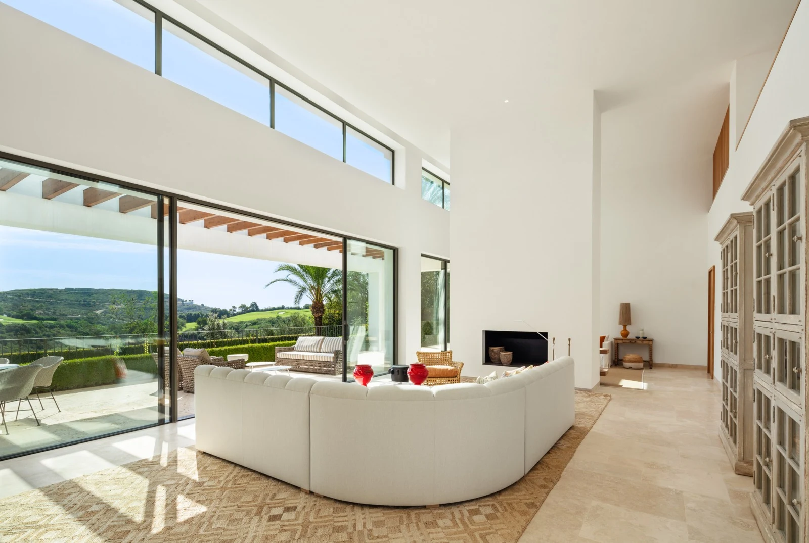 Bright living room with tall windows and a fireplace