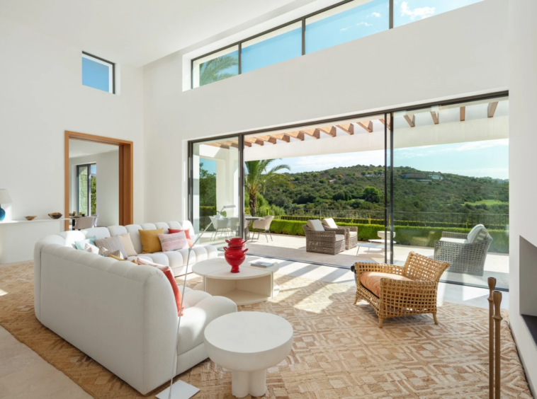 High-ceilinged seating area opening to the garden
