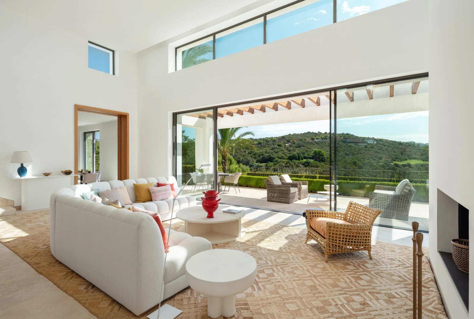 High-ceilinged seating area opening to the garden