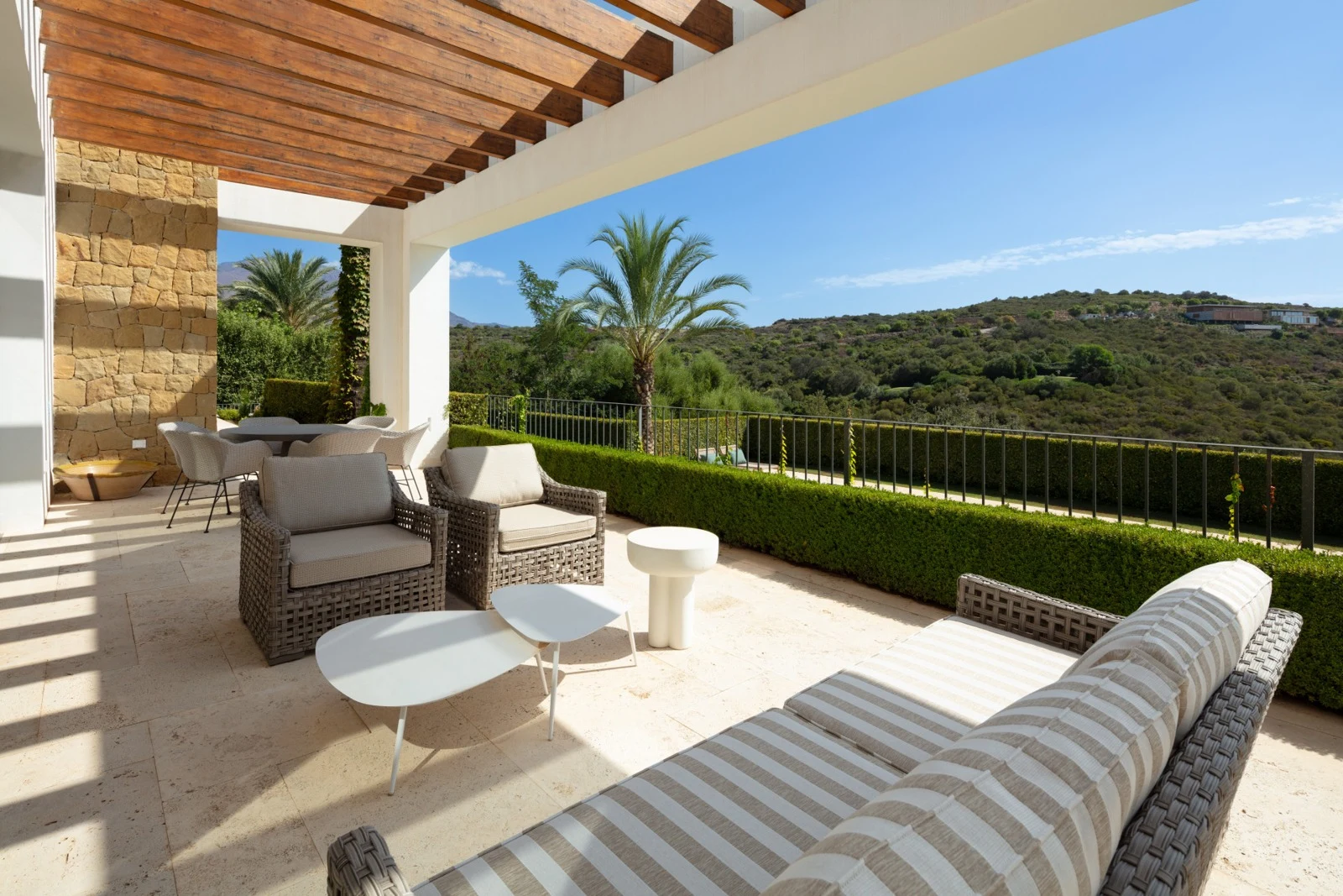 Shaded terrace with outdoor seating and golf views
