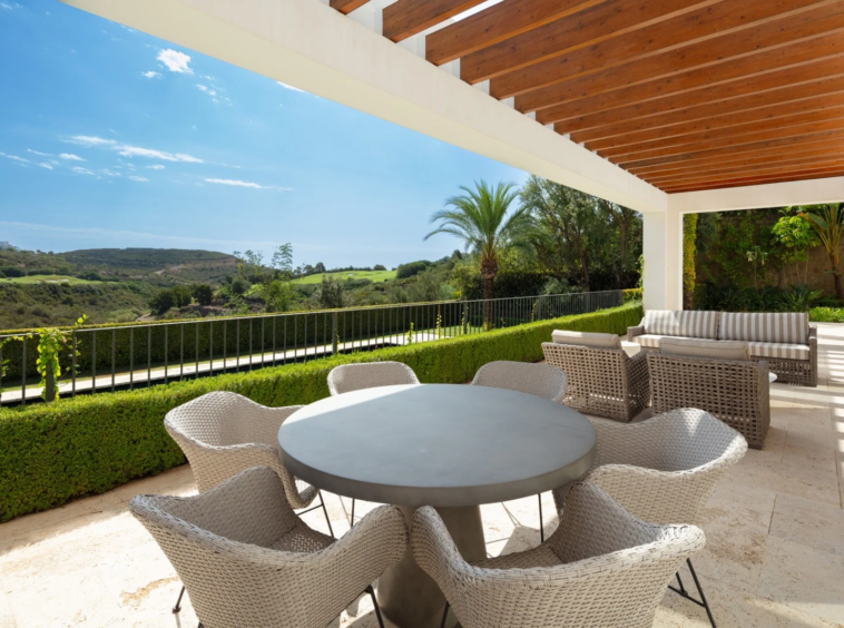 Covered outdoor dining terrace overlooking the golf course