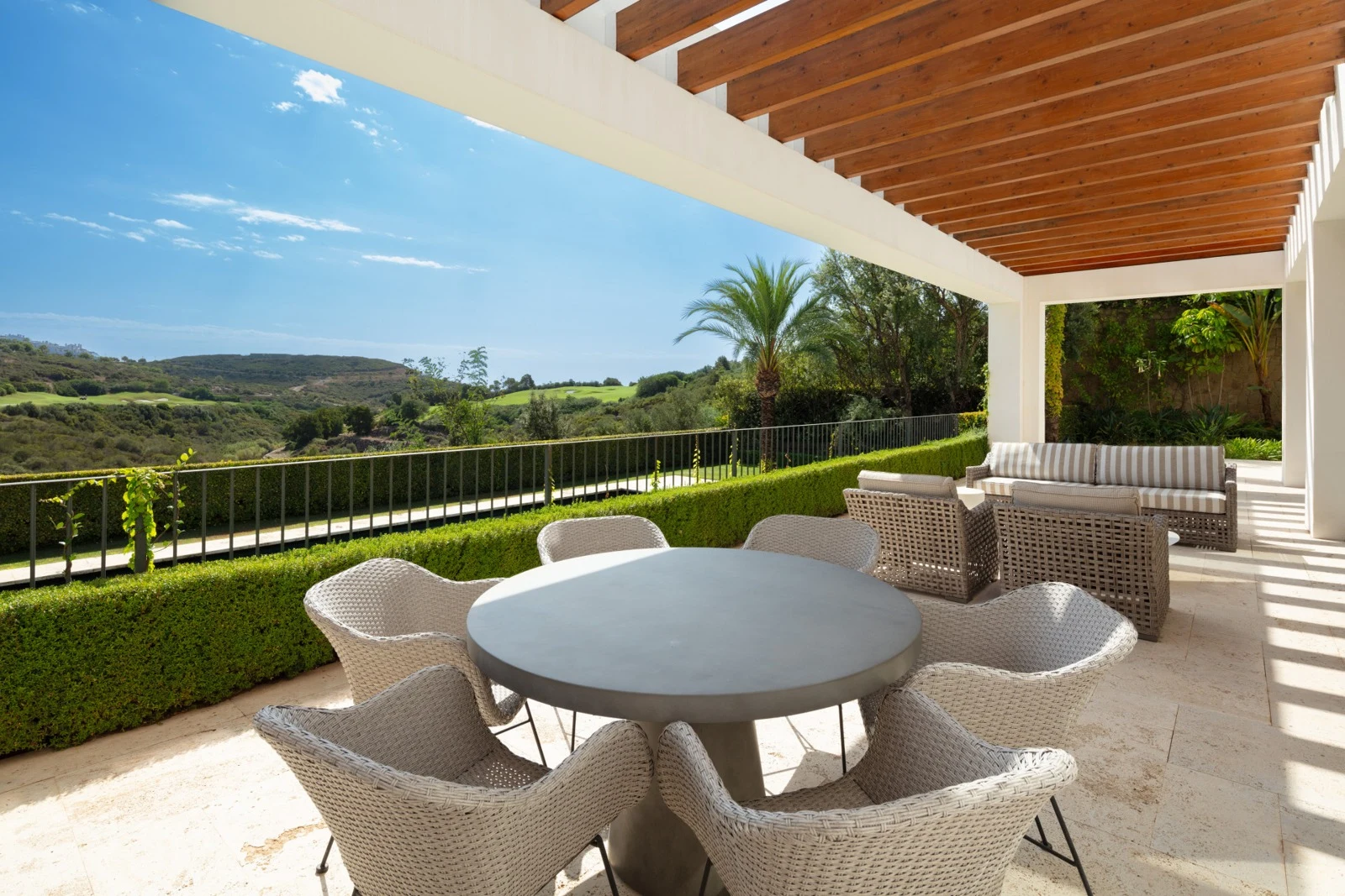 Covered outdoor dining terrace overlooking the golf course