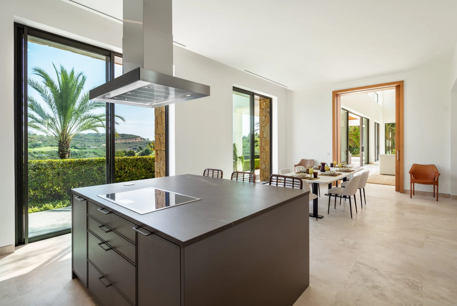 Kitchen island beside large garden-facing windows