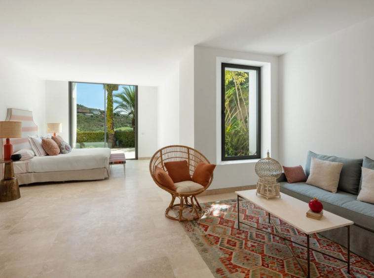 Spacious bedroom with lounge area and garden access