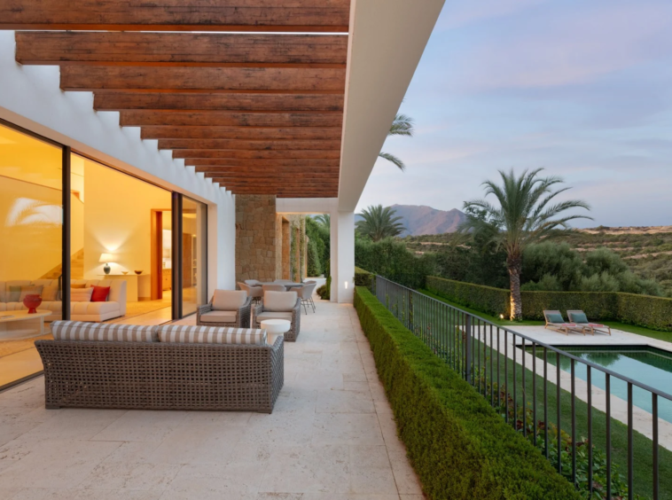 Covered terrace and pool at dusk