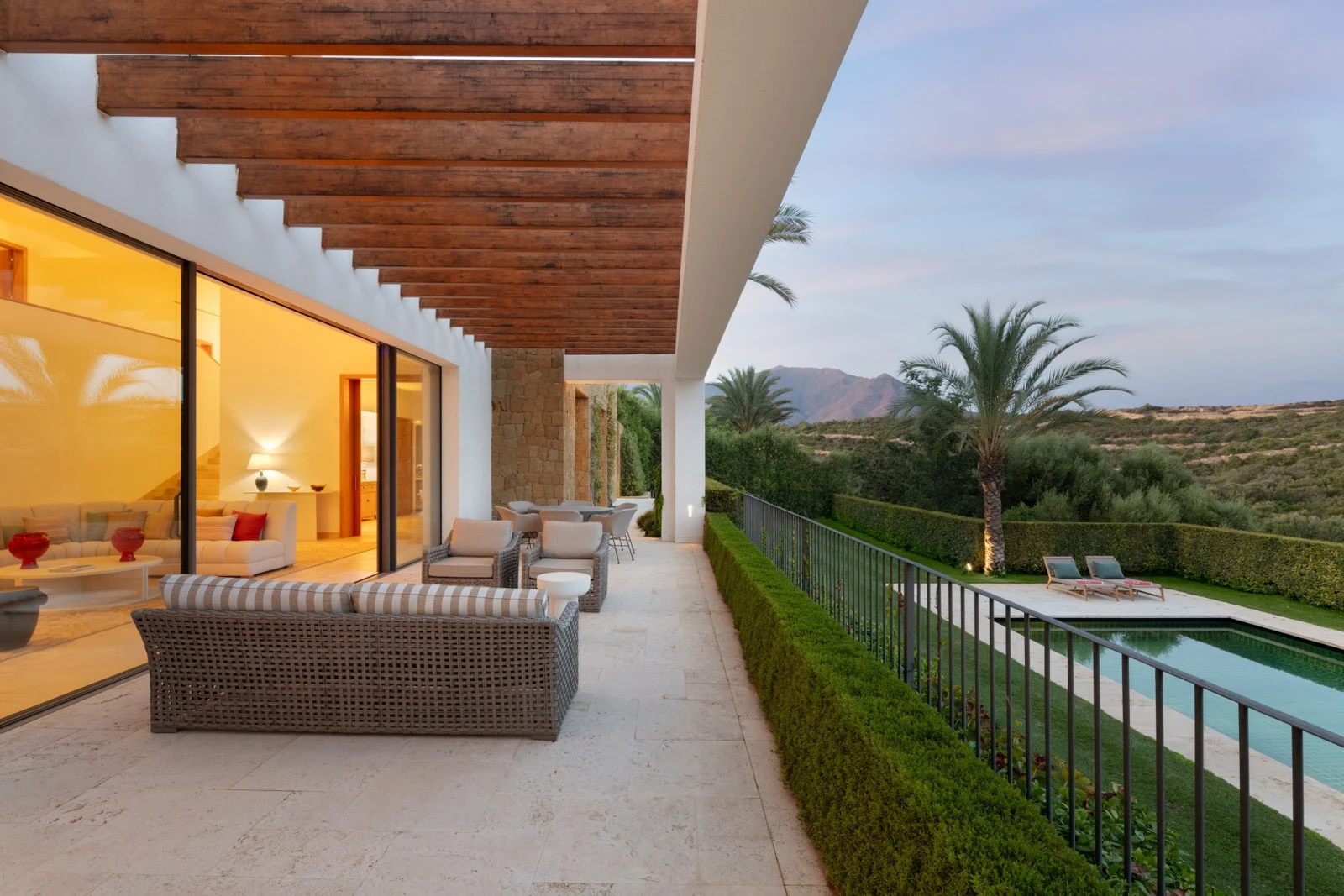 Covered terrace and pool at dusk