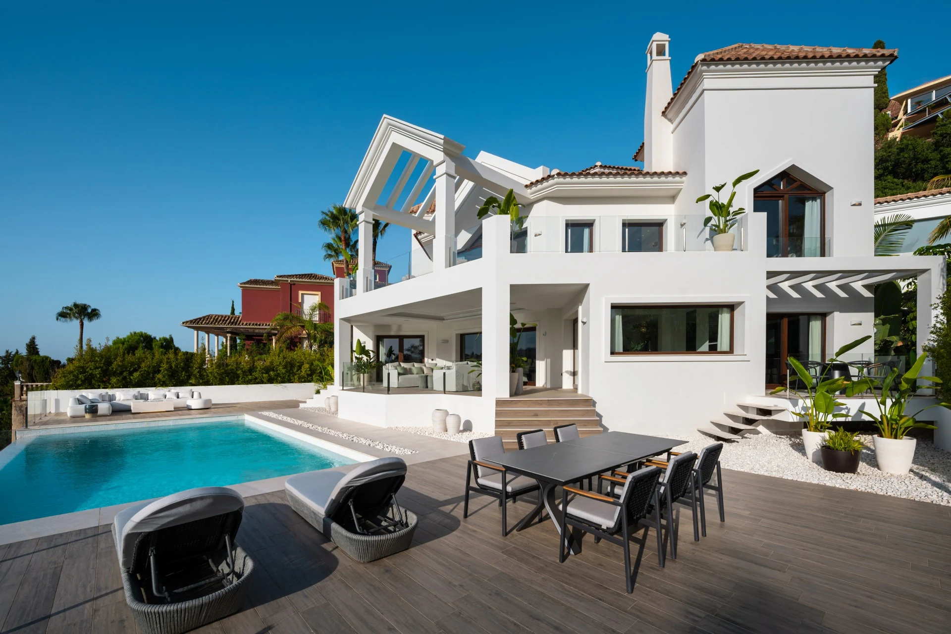 Private infinity pool beside the white villa facade