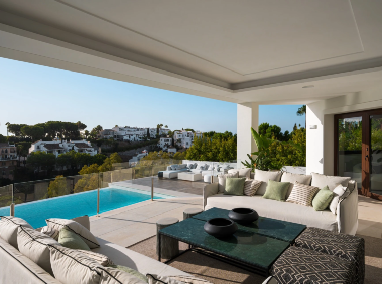 Covered lounge terrace overlooking the pool and neighbourhood
