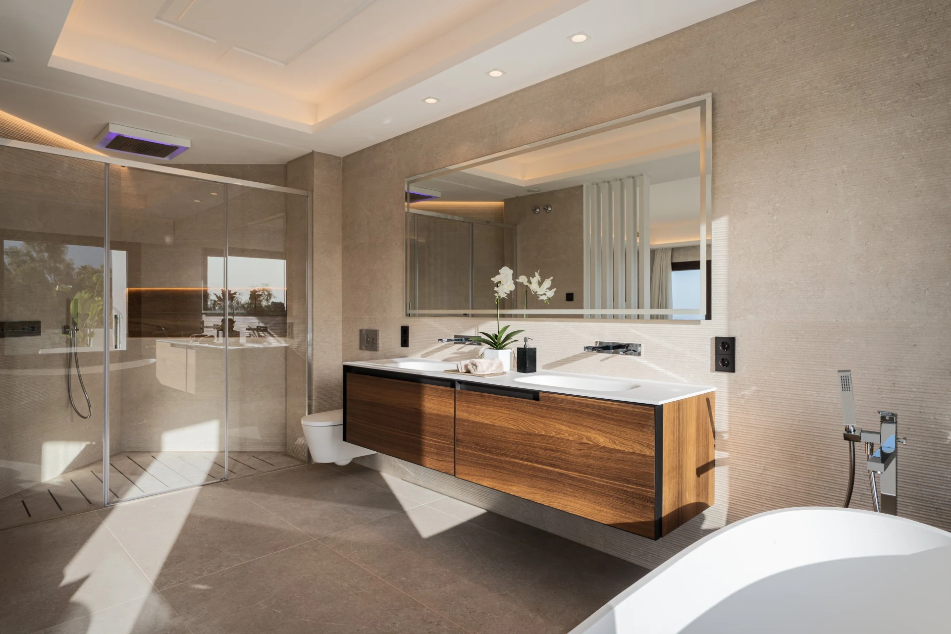Bathroom with double vanity and glass shower