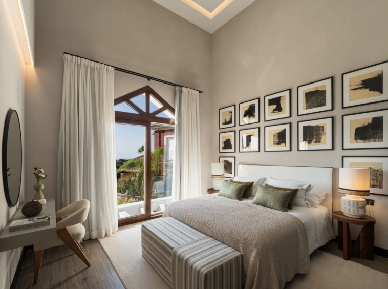 Guest bedroom with tall windows and fitted storage