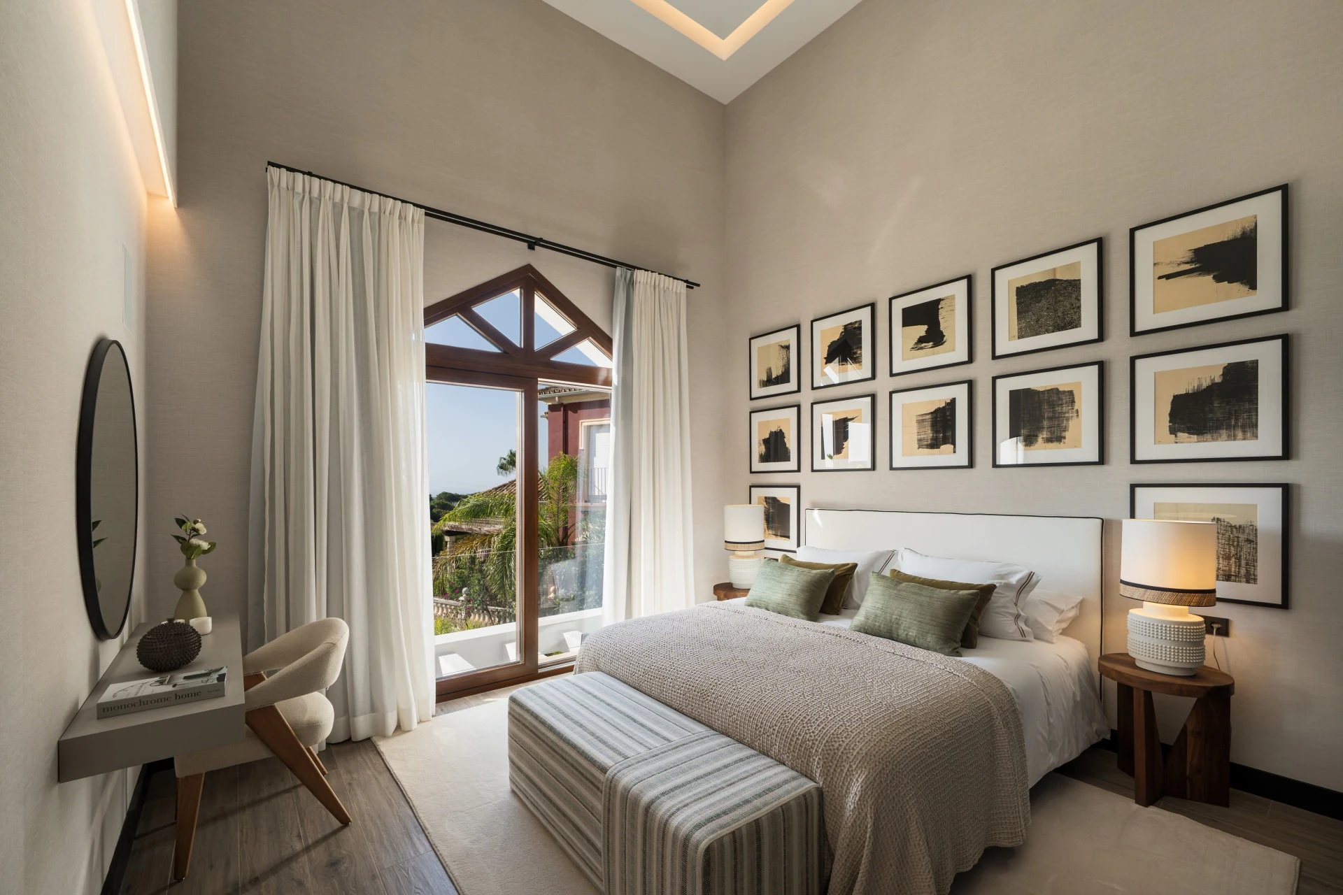 Guest bedroom with tall windows and fitted storage