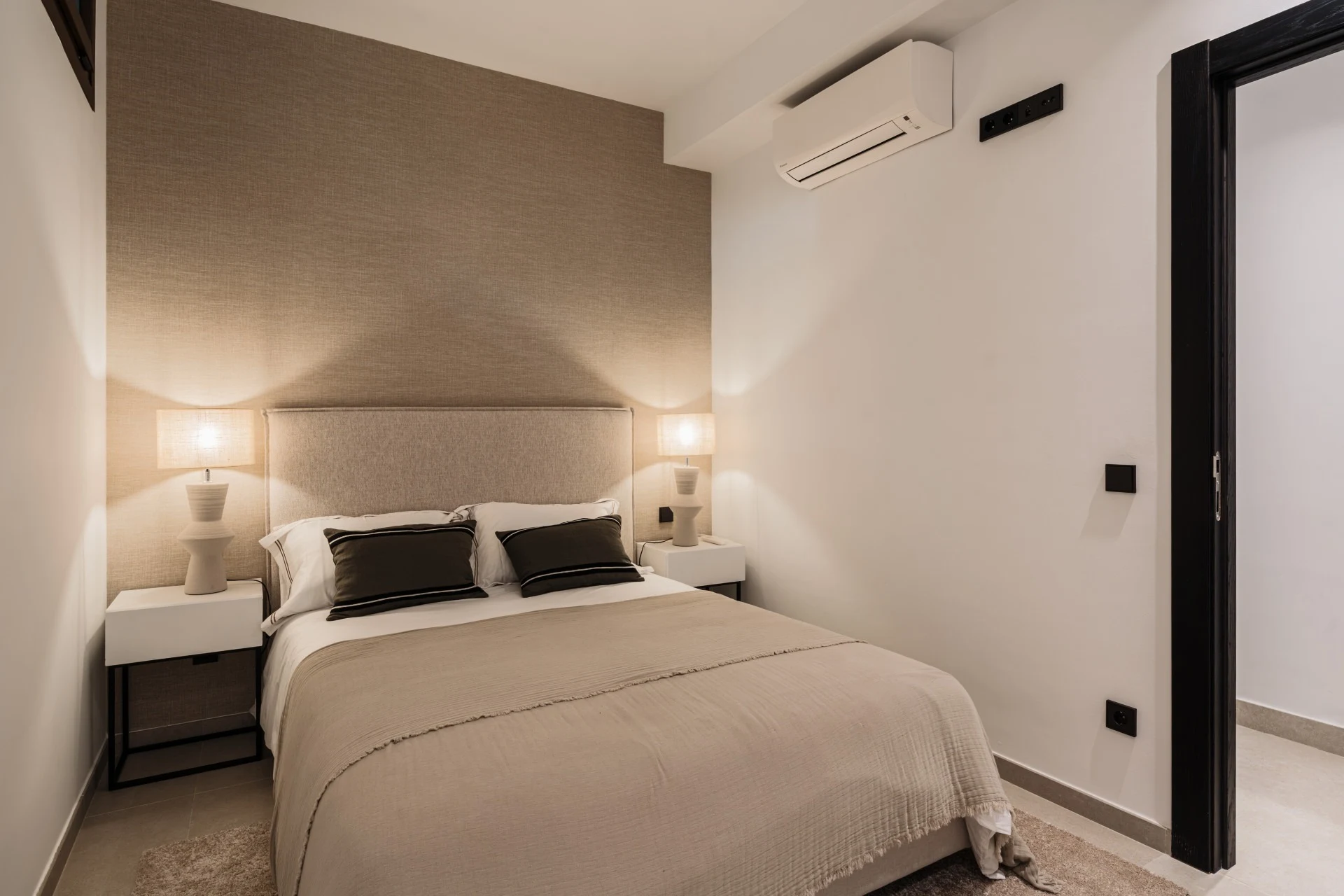 Lower-level guest bedroom with neutral finishes