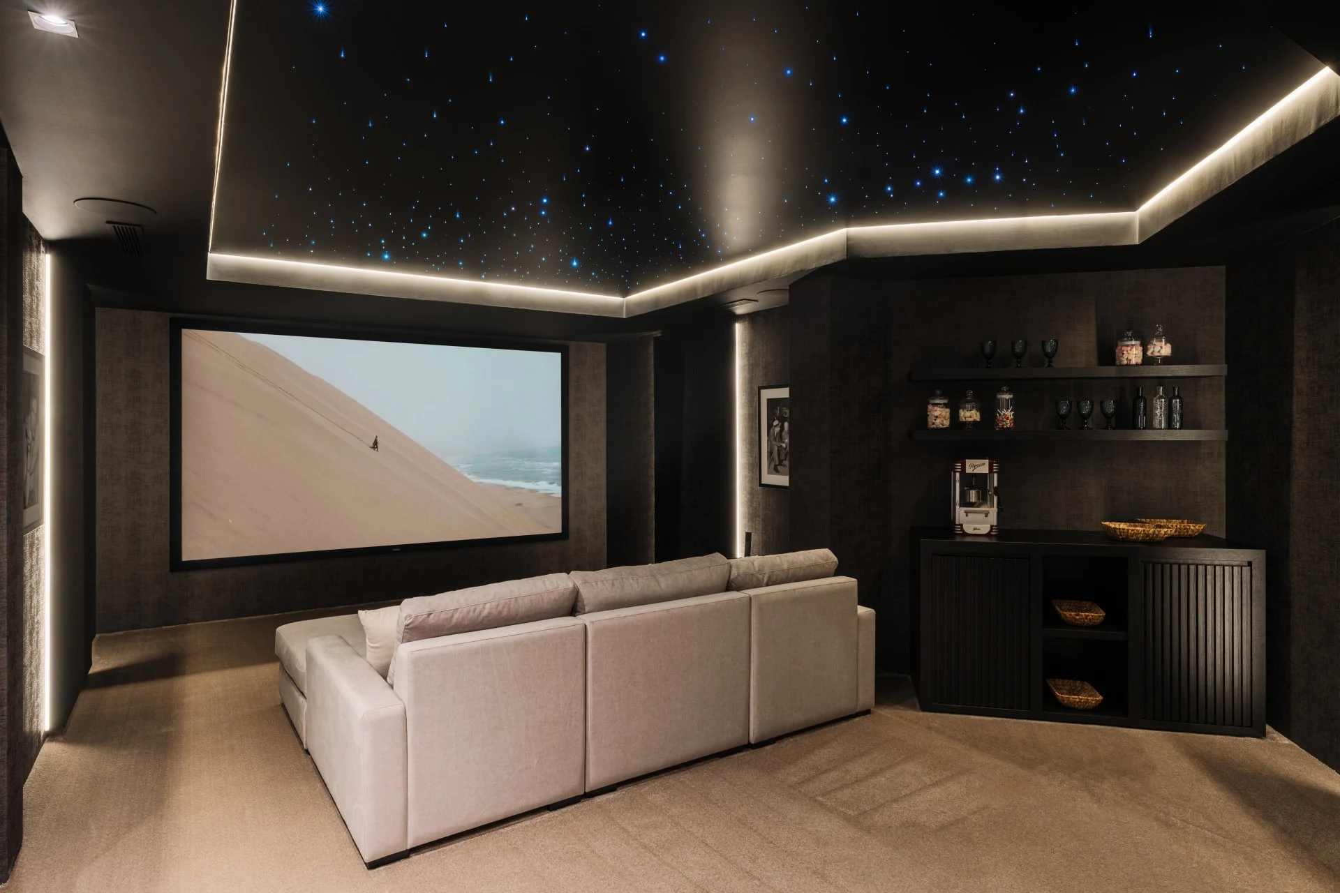 Private cinema room with large screen and lounge seating