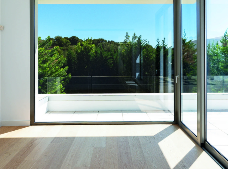 Bedroom window overlooking mature greenery in El Paraiso