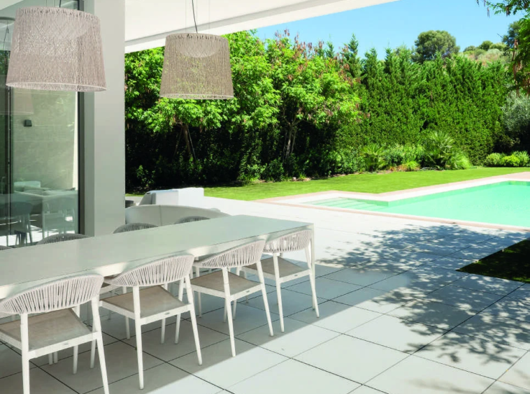 Covered dining terrace beside a private garden in El Paraiso